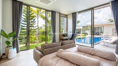 Living room with sliding glass doors and view of pool and garden