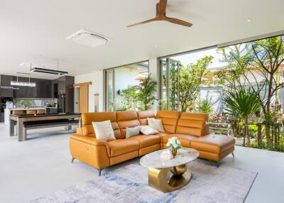 Modern living room with an open kitchen and garden view