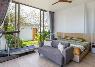 Modern bedroom with treadmill and large windows