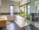 Modern bathroom with freestanding tub and large windows