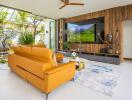 Modern living room with an orange sofa and large TV