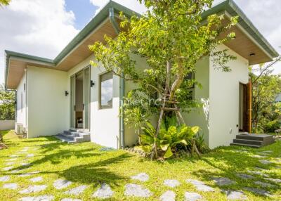 Exterior view of a modern house with lush greenery