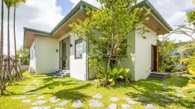 Exterior view of a modern house with lush greenery