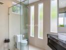 Modern bathroom with glass shower enclosure and sleek vanity area