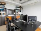 Modern home office with desk, computer monitors, and bookshelves