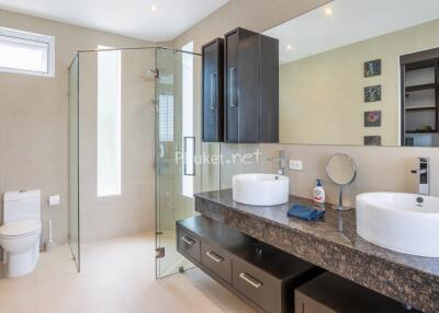 Modern bathroom with double sinks and glass shower