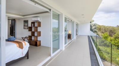 Modern bedroom and balcony with glass doors