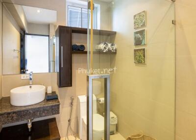 Modern bathroom with sink, shower, and toilet