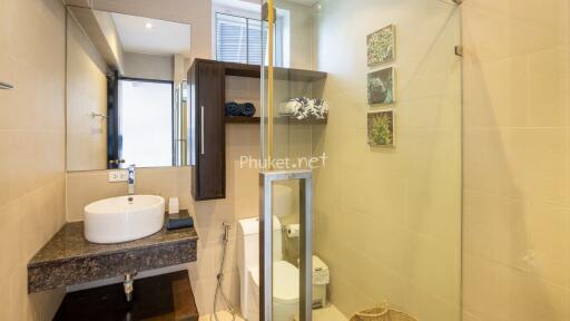 Modern bathroom with sink, shower, and toilet