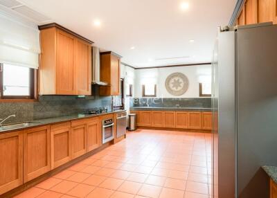 Spacious kitchen with wooden cabinets and modern appliances