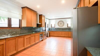 Spacious kitchen with wooden cabinets and modern appliances