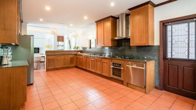 Spacious kitchen with wooden cabinets and modern appliances