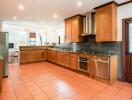 Spacious kitchen with wooden cabinets and modern appliances