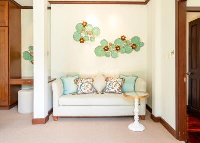 Cozy bedroom corner with sofa and decorative wall art