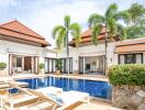 Outdoor pool area with sun loungers and palm trees