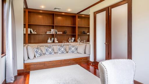 Cozy reading nook with built-in wooden bookshelves and a cushioned bench