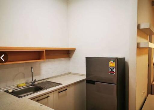 Modern kitchen with stainless steel refrigerator
