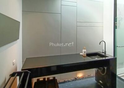 Modern kitchen with sleek cabinetry and black countertop