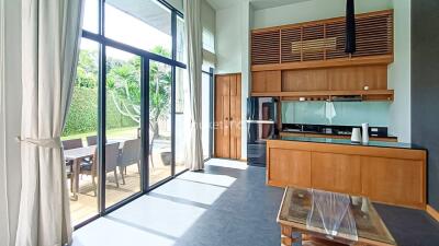 Modern kitchen with large windows and an adjacent outdoor space