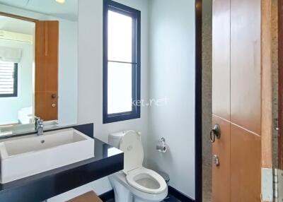 Modern bathroom with sink, mirror, and toilet