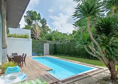 Backyard with swimming pool and seating area