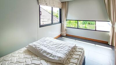 Bedroom with a bed and large windows