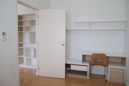 Bedroom with work desk and shelving unit