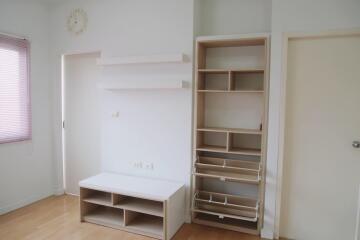 Organized bedroom storage area with shelves and drawers