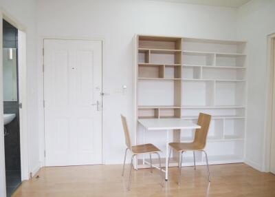 Minimalist dining area with white table and wooden chairs