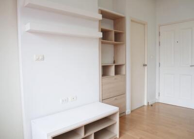 Minimalistic hallway with storage shelves and white door