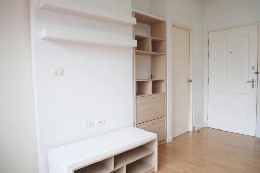 Minimalistic hallway with storage shelves and white door