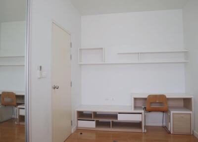 Minimalist bedroom with desk and shelving