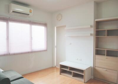 Living room with air conditioner and built-in shelves