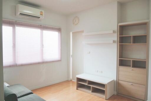 Living room with air conditioner and built-in shelves