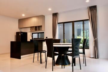 Modern kitchen and dining area with round table and black chairs