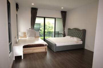 Spacious bedroom with two beds and large windows