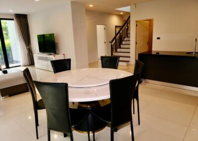 Modern living area with dining table and open kitchen