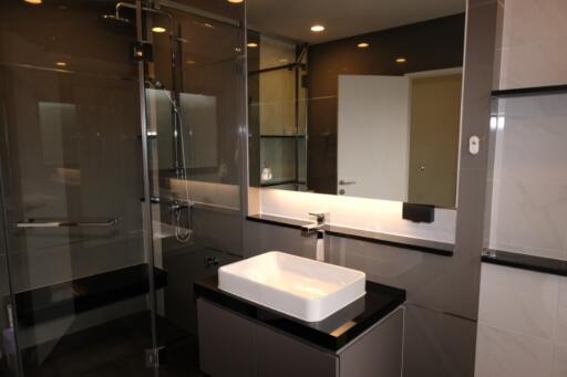 Modern bathroom with glass shower and white sink