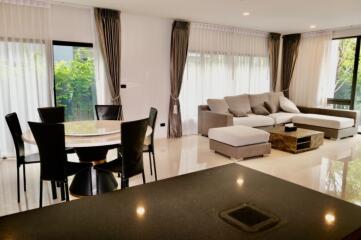 Spacious living room with dining area and natural light