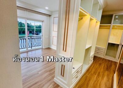 Spacious master bedroom with wooden flooring and ample closet space