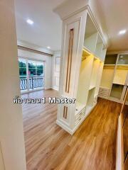 Spacious master bedroom with wooden flooring and ample closet space