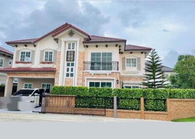 Front exterior view of a large house with landscaped yard