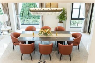 Elegant dining room with large windows and chandelier