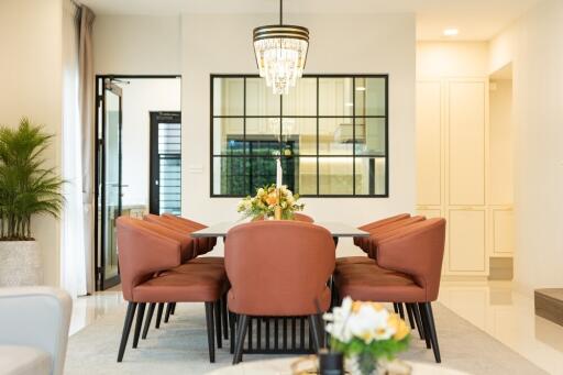 Modern dining room with a chandelier and a large window