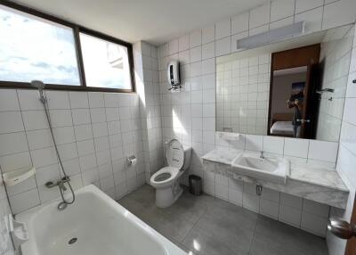 Modern bathroom with white tiles and bathtub