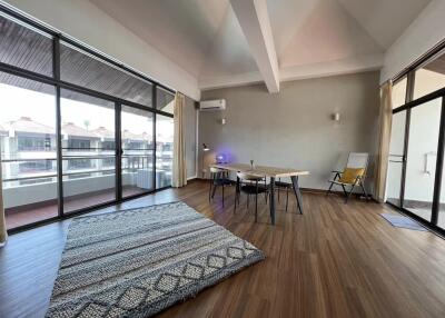 spacious living room with large windows and wooden floor