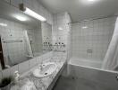 Modern bathroom with white tiles and a marble countertop