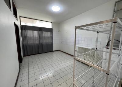 Spacious utility room with tiled flooring and shelving