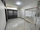 Spacious utility room with tiled flooring and shelving