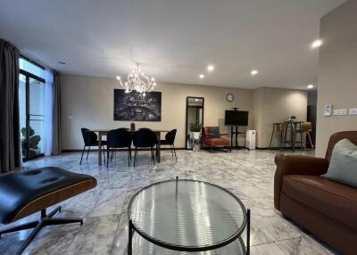 spacious modern living room with dining area and chandelier